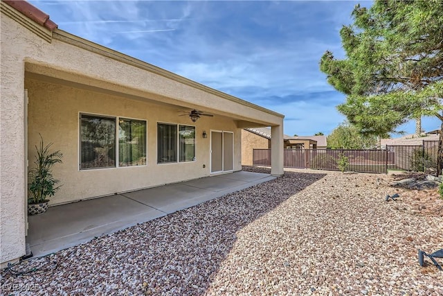 view of yard with a patio area, a ceiling fan, and fence