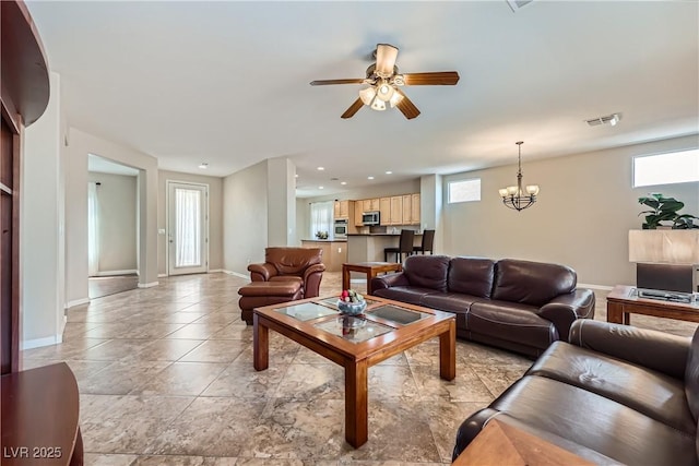 living area with visible vents, baseboards, light tile patterned flooring, recessed lighting, and ceiling fan with notable chandelier
