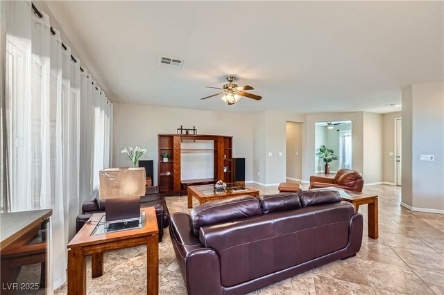 living room featuring visible vents, baseboards, and ceiling fan