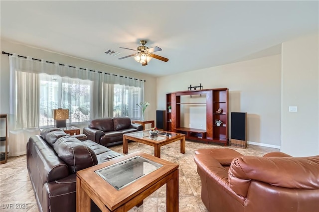 living room with visible vents, baseboards, and a ceiling fan
