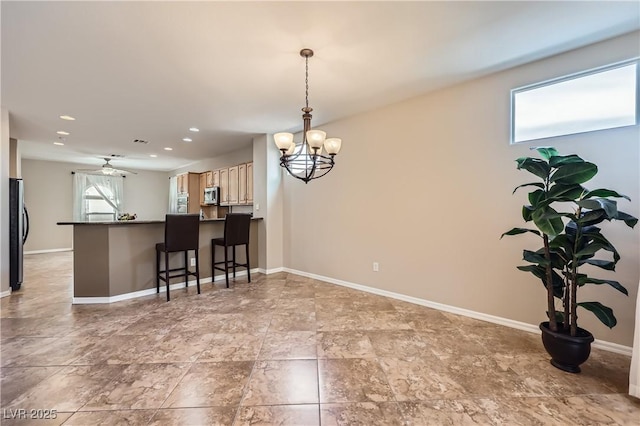kitchen with a notable chandelier, baseboards, and appliances with stainless steel finishes