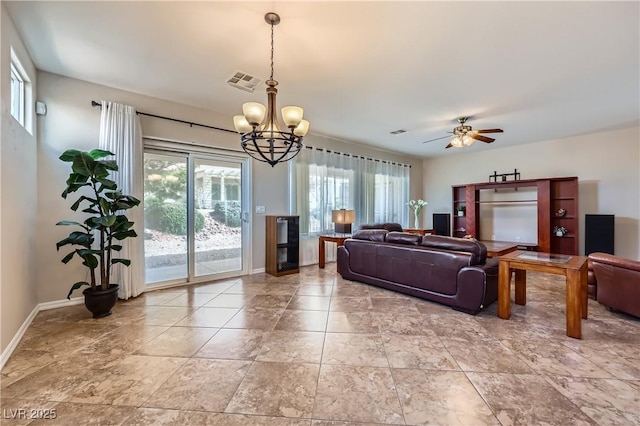 living room with visible vents, baseboards, and ceiling fan with notable chandelier