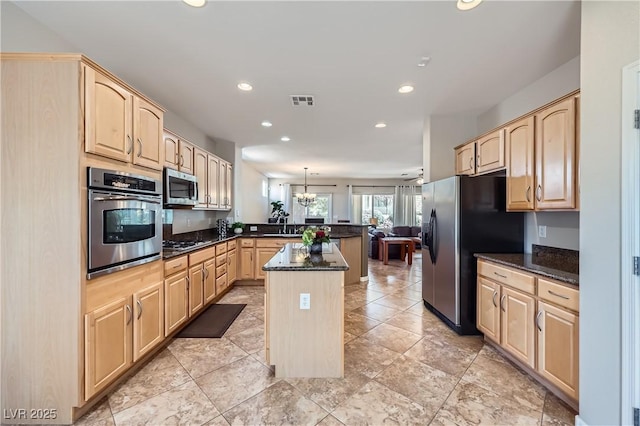kitchen with light brown cabinets, open floor plan, recessed lighting, appliances with stainless steel finishes, and a peninsula
