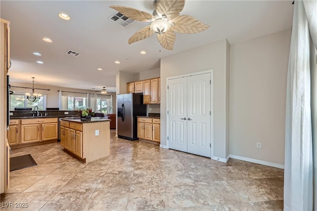 kitchen featuring light brown cabinetry, visible vents, a ceiling fan, and stainless steel refrigerator with ice dispenser