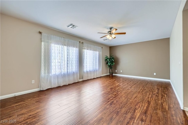 empty room featuring visible vents, baseboards, ceiling fan, and wood finished floors