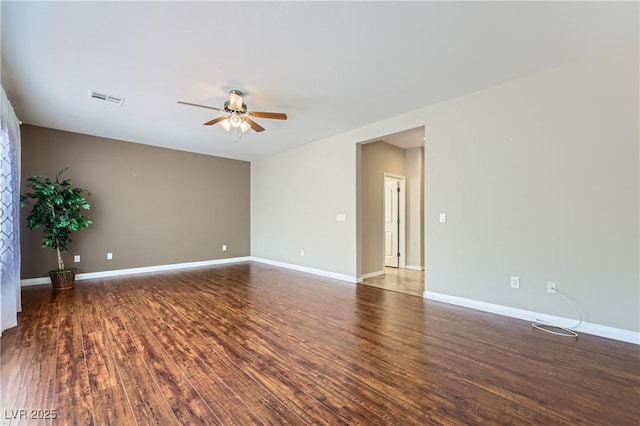 unfurnished room with visible vents, baseboards, a ceiling fan, and wood finished floors