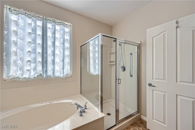 full bath with a garden tub and a stall shower