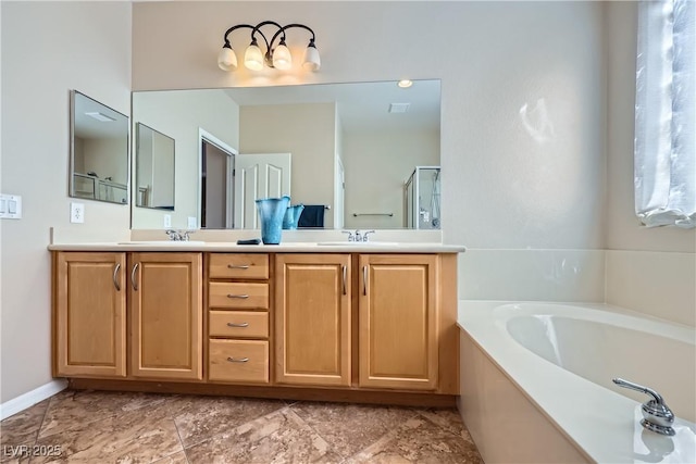 full bath with a bath, a shower stall, double vanity, and a sink