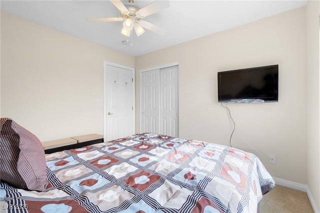 bedroom with carpet flooring, a closet, baseboards, and ceiling fan