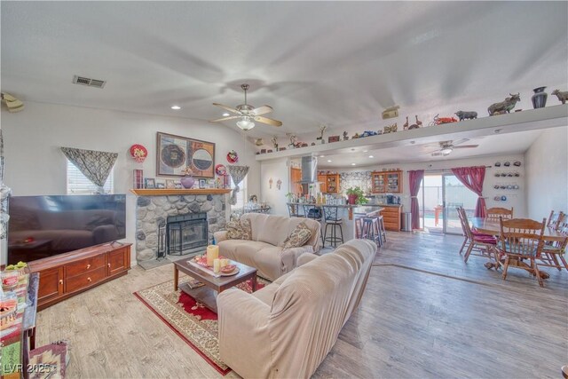 3424 Mount Charleston Dr, Pahrump, NV 89048 - living room featuring ceiling fan, light wood-type flooring, a fireplace, and lofted ceiling