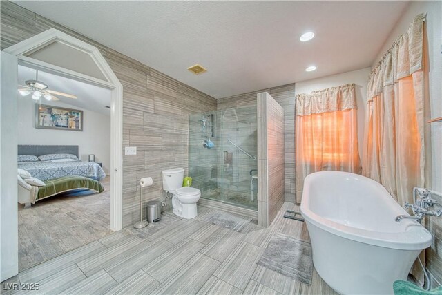 3424 Mount Charleston Dr, Pahrump, NV 89048 - full bathroom with ensuite bathroom, a stall shower, a soaking tub, toilet, and recessed lighting