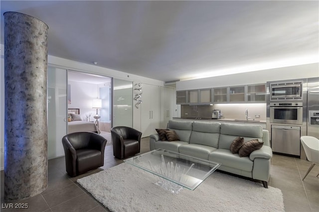 living area with tile patterned floors