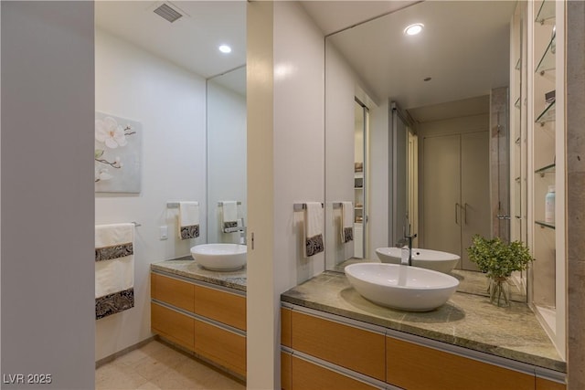 full bath featuring vanity, recessed lighting, and visible vents