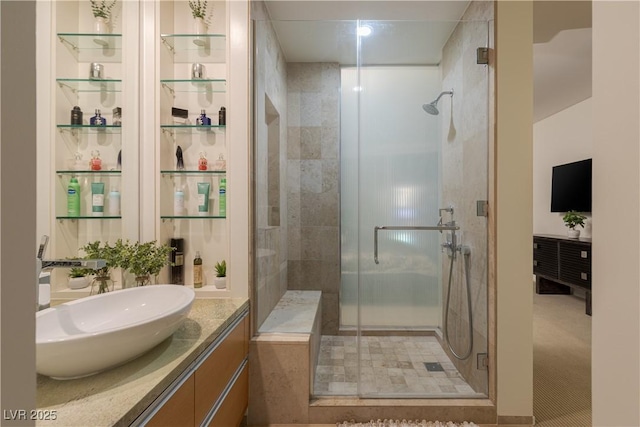 full bath with a shower stall and vanity