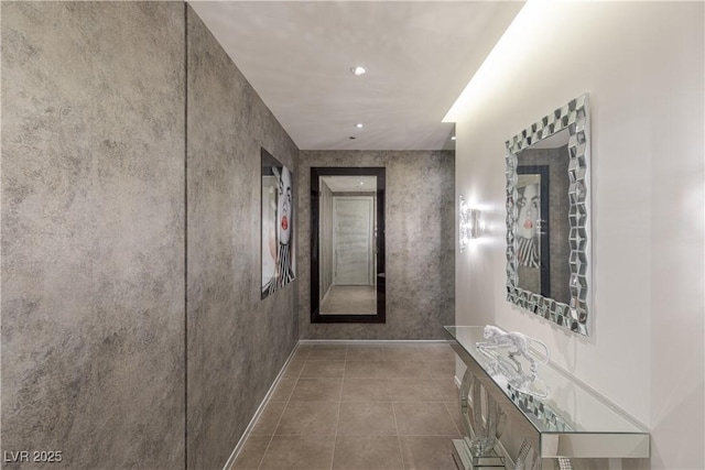 corridor with baseboards, tile patterned flooring, and recessed lighting