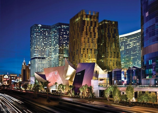 property at night featuring a view of city lights