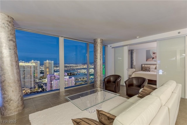 tiled living area with a city view and expansive windows