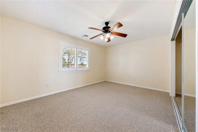unfurnished bedroom with baseboards, ceiling fan, visible vents, and carpet