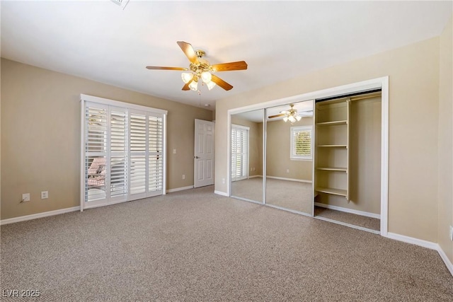 unfurnished bedroom with baseboards, a ceiling fan, a closet, and carpet