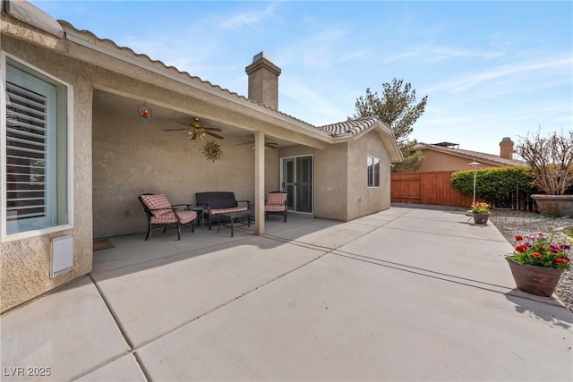 view of patio / terrace featuring fence and a ceiling fan