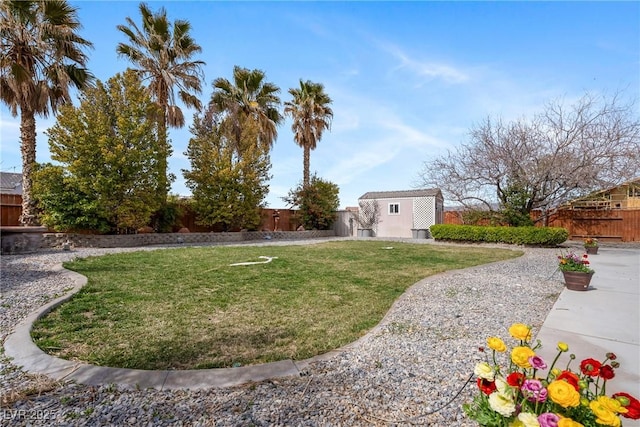 view of yard featuring a fenced backyard and an outbuilding