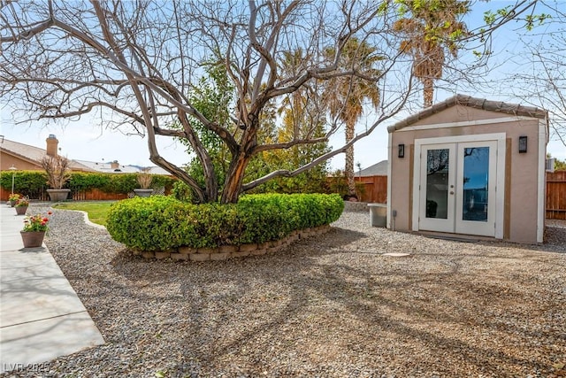 view of yard featuring an outdoor structure and fence