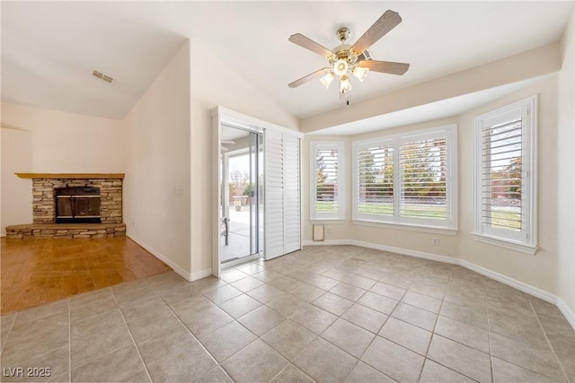 unfurnished living room featuring light tile patterned flooring, visible vents, lofted ceiling, and ceiling fan