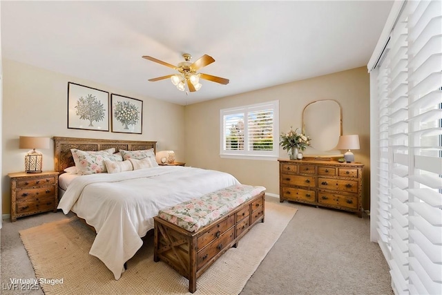 bedroom featuring light carpet, baseboards, and ceiling fan