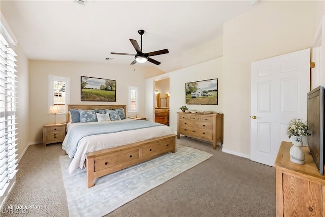 bedroom with vaulted ceiling, carpet flooring, a ceiling fan, baseboards, and visible vents