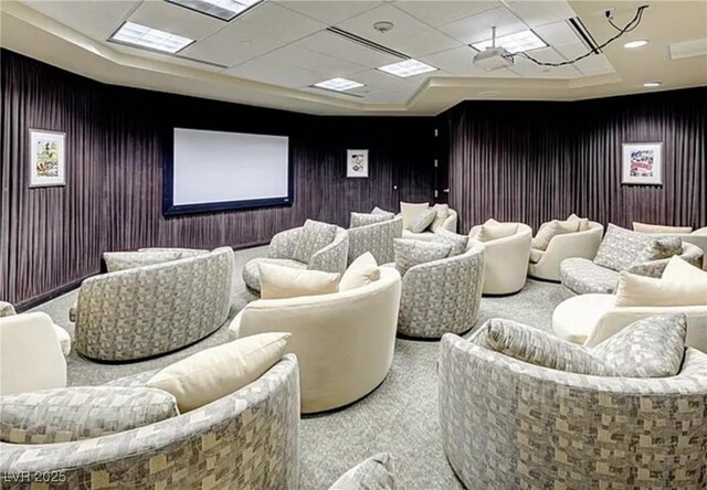 carpeted home theater room featuring a tray ceiling