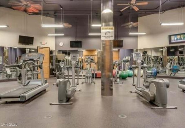 exercise room featuring a towering ceiling and a ceiling fan