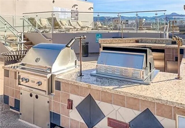 view of patio with a mountain view and area for grilling