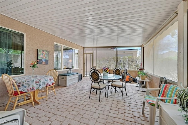 7741 Fruit Dove St, North Las Vegas, NV 89084 - sunroom / solarium with outdoor dining area, brick patterned floors, and healthy amount of natural light