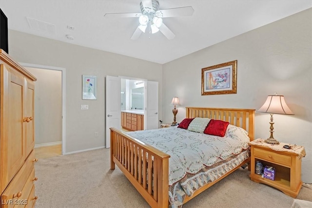 7741 Fruit Dove St, North Las Vegas, NV 89084 - bedroom featuring light carpet, baseboards, ensuite bath, and a ceiling fan