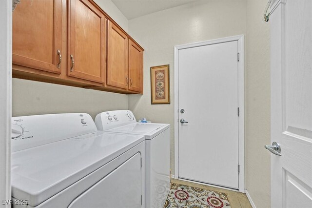 7741 Fruit Dove St, North Las Vegas, NV 89084 - laundry area with washer and dryer, cabinet space, baseboards, and light tile patterned flooring