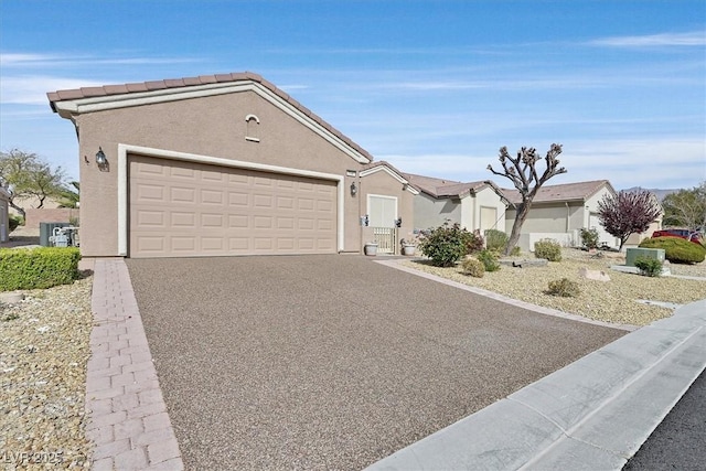 7741 Fruit Dove St, North Las Vegas, NV 89084 - ranch-style house with driveway, a garage, and stucco siding