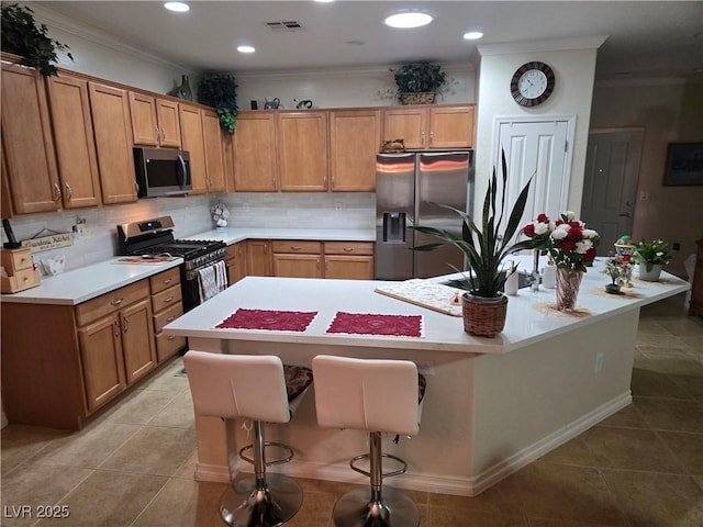 7741 Fruit Dove St, North Las Vegas, NV 89084 - kitchen with appliances with stainless steel finishes, light countertops, ornamental molding, light tile patterned floors, and decorative backsplash