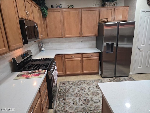 7741 Fruit Dove St, North Las Vegas, NV 89084 - kitchen with stainless steel fridge with ice dispenser, gas range oven, black microwave, and tasteful backsplash
