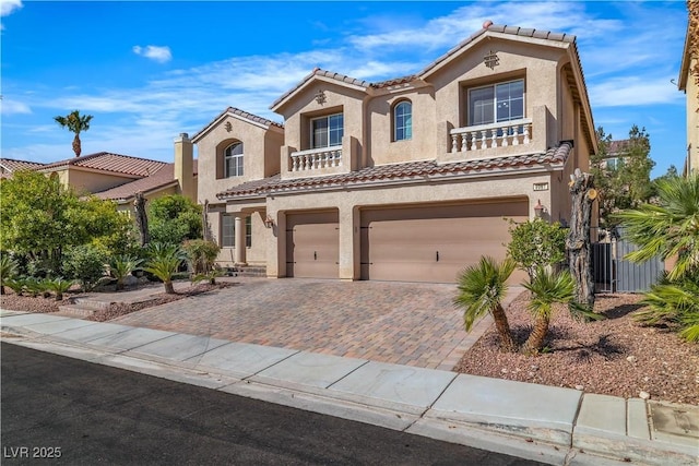 9967 Pipestone St, Las Vegas, NV 89141 - mediterranean / spanish home with an attached garage, stucco siding, a tile roof, and decorative driveway