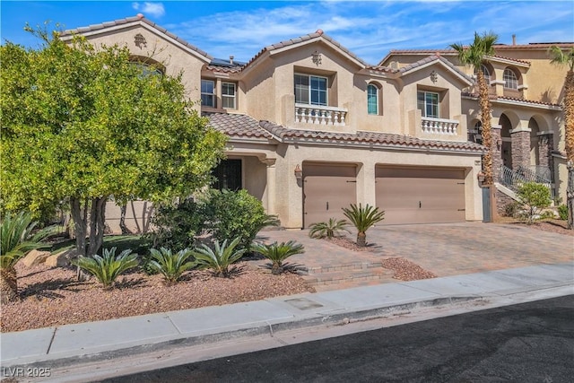 9967 Pipestone St, Las Vegas, NV 89141 - mediterranean / spanish home featuring an attached garage, stucco siding, a tile roof, decorative driveway, and roof mounted solar panels