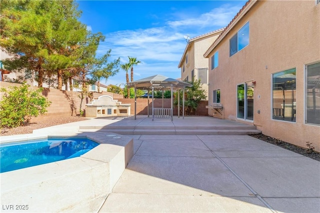 9967 Pipestone St, Las Vegas, NV 89141 - view of pool featuring a gazebo, a patio area, a fenced backyard, and an outdoor kitchen