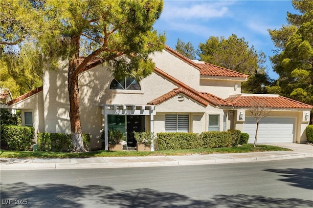 6923 Emerald Springs Ln, Las Vegas, NV 89113 - mediterranean / spanish-style house featuring a garage, a tiled roof, stucco siding, and concrete driveway
