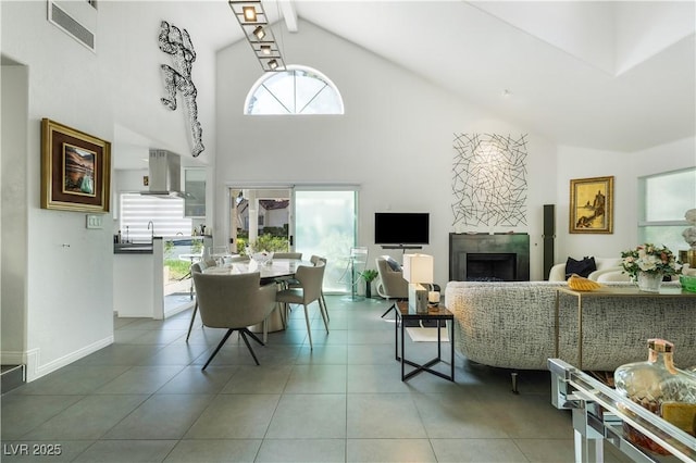 6923 Emerald Springs Ln, Las Vegas, NV 89113 - living room with high vaulted ceiling, a premium fireplace, and tile patterned flooring