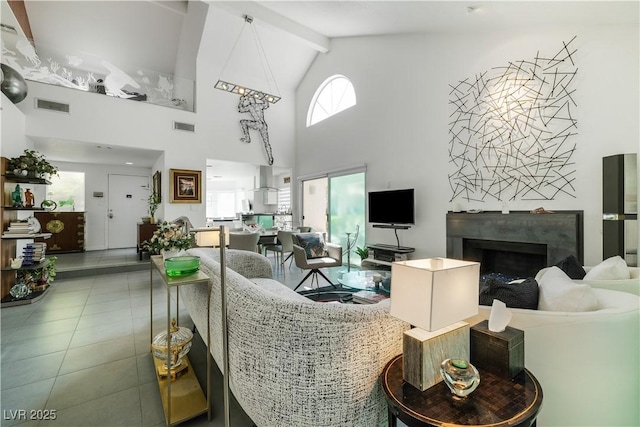 6923 Emerald Springs Ln, Las Vegas, NV 89113 - tiled living area featuring high vaulted ceiling, beamed ceiling, and a premium fireplace