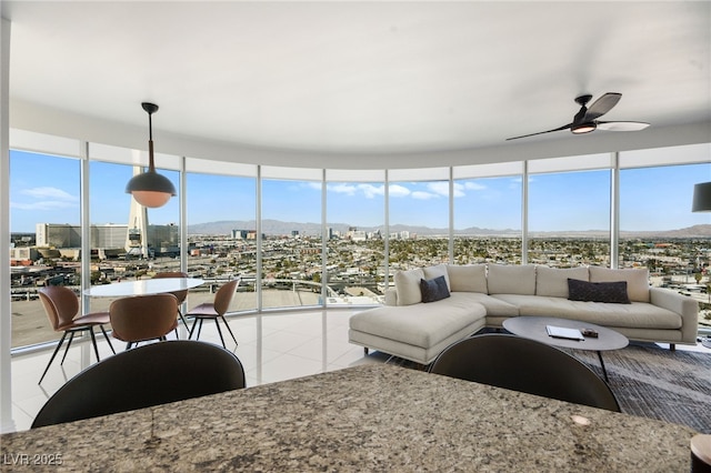 322 Karen Ave Unit 1507, Las Vegas, NV 89109 - living room featuring a mountain view, ceiling fan, and light tile patterned floors