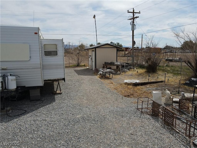 4861 Pahrump Valley Blvd, Pahrump, NV 89048 - view of yard with an outbuilding, a storage unit, and fence