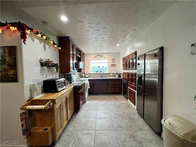 4861 Pahrump Valley Blvd, Pahrump, NV 89048 - kitchen with light countertops, recessed lighting, stainless steel fridge with ice dispenser, a sink, and dark brown cabinets