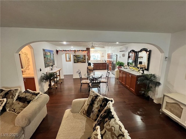 4861 Pahrump Valley Blvd, Pahrump, NV 89048 - living area with a ceiling fan, arched walkways, dark wood-type flooring, and an AC wall unit