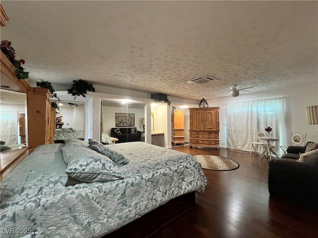 4861 Pahrump Valley Blvd, Pahrump, NV 89048 - bedroom featuring a textured ceiling, visible vents, and dark wood finished floors
