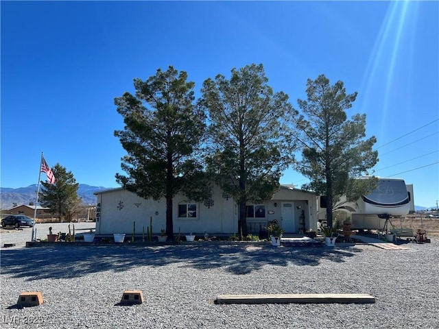 view of front of property featuring stucco siding and a mountain view